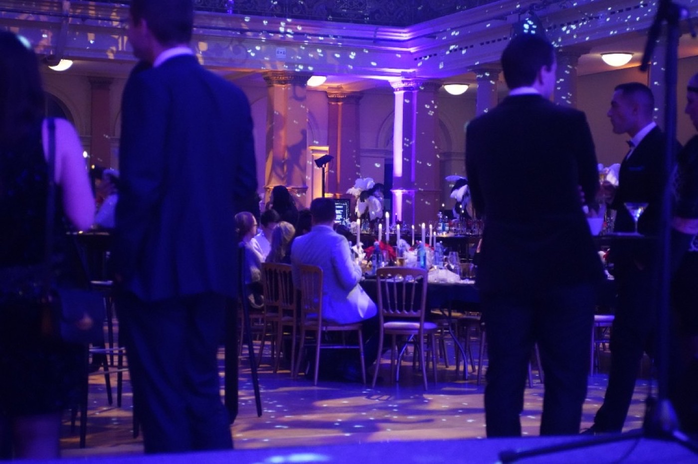 Christmas party in Frankfurt with purple event lighting, candlelight and guests in evening wear